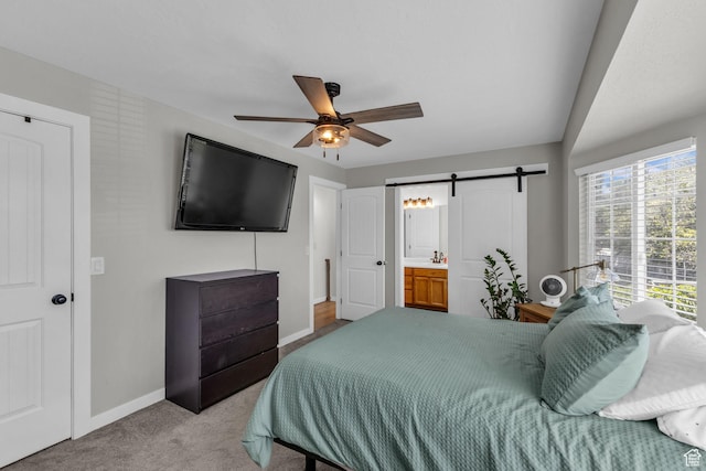 6169 Longmore Dr, Salt Lake City, UT 84118 - bedroom with a barn door, baseboards, carpet floors, ceiling fan, and connected bathroom