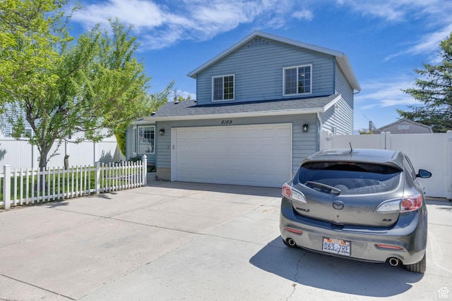 6169 Longmore Dr, Salt Lake City, UT 84118 - view of front facade featuring an attached garage and concrete driveway