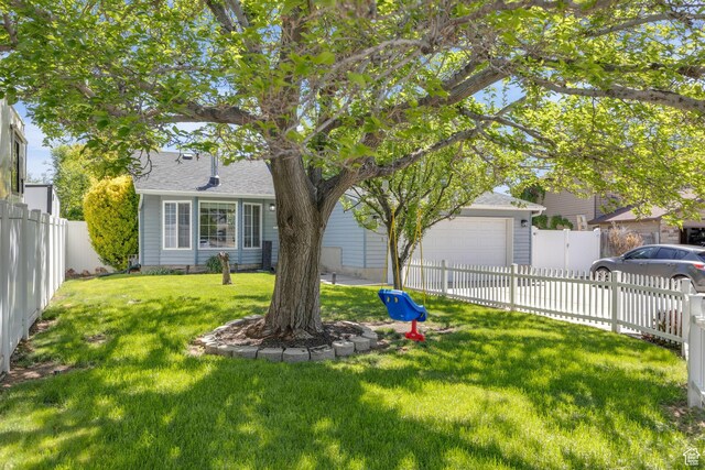 6169 Longmore Dr, Salt Lake City, UT 84118 - view of yard featuring driveway and an attached garage