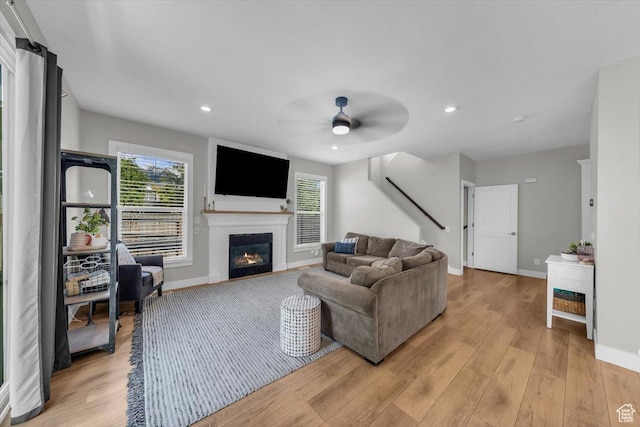 441 E Crape Myrtle Cir, Draper, UT 84020 - living room featuring stairway, ceiling fan, baseboards, light wood-style flooring, and plenty of natural light