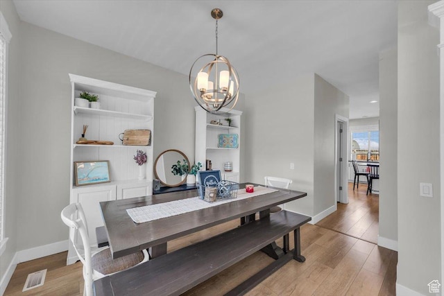 441 E Crape Myrtle Cir, Draper, UT 84020 - dining space featuring wood-type flooring, a chandelier, and baseboards