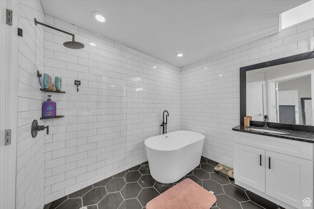 441 E Crape Myrtle Cir, Draper, UT 84020 - bathroom with tile walls, vanity, a freestanding bath, tile patterned flooring, and recessed lighting