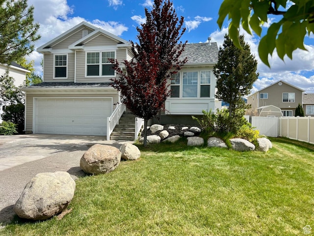 376 E 770 N, Tooele, UT 84074 - view of front of home featuring a garage, driveway, stairway, and a shingled roof