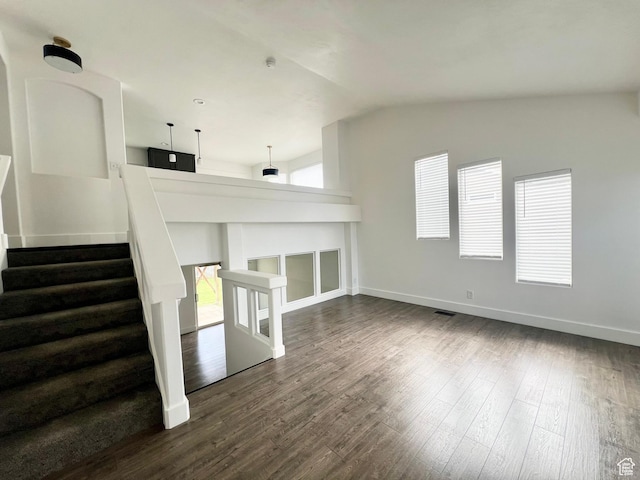 376 E 770 N, Tooele, UT 84074 - unfurnished living room featuring vaulted ceiling, dark wood-style floors, baseboards, and stairs