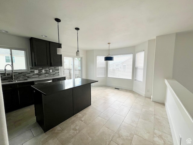 376 E 770 N, Tooele, UT 84074 - kitchen with a sink, dark cabinetry, decorative backsplash, and healthy amount of natural light