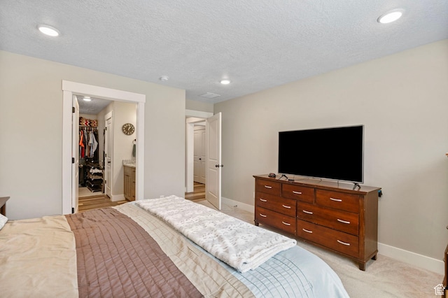 641 E Green Springs Way Unit 324, South Weber, UT 84405 - bedroom with baseboards, a spacious closet, recessed lighting, light colored carpet, and a textured ceiling