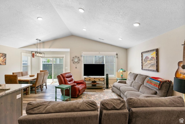 641 E Green Springs Way Unit 324, South Weber, UT 84405 - living room featuring lofted ceiling, light wood-style floors, and a textured ceiling