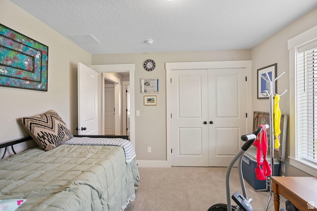 641 E Green Springs Way Unit 324, South Weber, UT 84405 - bedroom featuring carpet flooring, multiple windows, a closet, and a textured ceiling