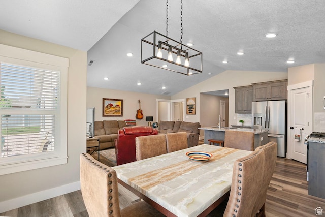 641 E Green Springs Way Unit 324, South Weber, UT 84405 - dining area featuring vaulted ceiling, dark wood-type flooring, and baseboards