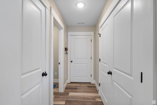 641 E Green Springs Way Unit 324, South Weber, UT 84405 - hallway featuring a textured ceiling, wood finished floors, and baseboards
