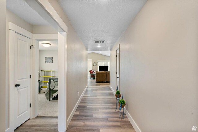 641 E Green Springs Way Unit 324, South Weber, UT 84405 - hall featuring wood finished floors, a textured ceiling, and baseboards