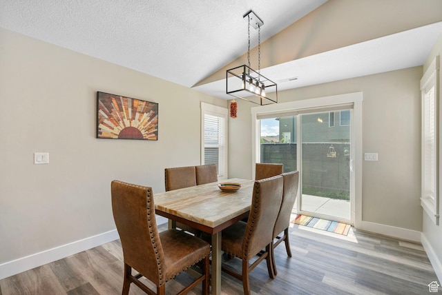 641 E Green Springs Way Unit 324, South Weber, UT 84405 - dining space with lofted ceiling, wood finished floors, baseboards, and a textured ceiling