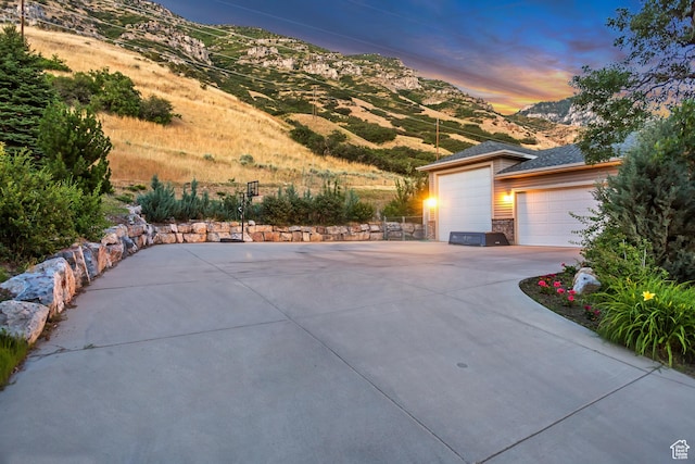 3286 N Piute Dr, Provo, UT 84604 - property exterior at dusk with a mountain view and driveway