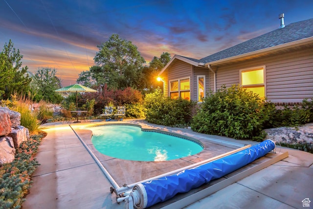 3286 N Piute Dr, Provo, UT 84604 - pool at dusk with a patio and a covered pool
