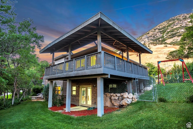 3286 N Piute Dr, Provo, UT 84604 - back of house at dusk featuring a deck, french doors, and brick siding