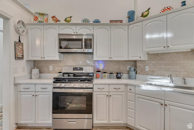 3286 N Piute Dr, Provo, UT 84604 - kitchen with stainless steel appliances, white cabinetry, a sink, and light countertops