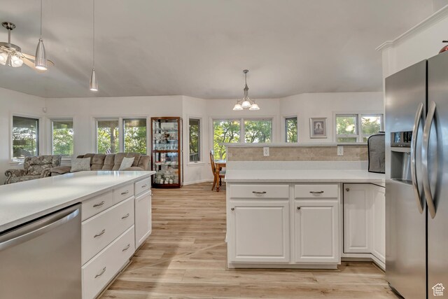 3286 N Piute Dr, Provo, UT 84604 - kitchen featuring appliances with stainless steel finishes, light countertops, light wood-type flooring, and a chandelier
