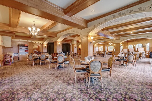 840 Bigler Ln Unit 2021, Midway, UT 84049 - carpeted dining area featuring beamed ceiling, a chandelier, ornate columns, ornamental molding, and arched walkways