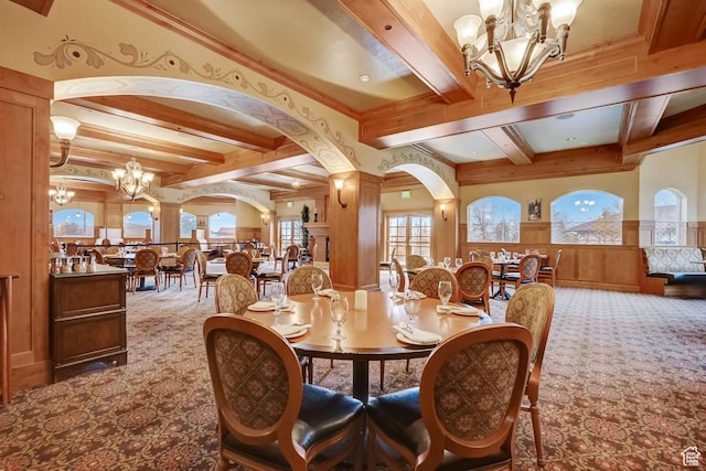 840 Bigler Ln Unit 2021, Midway, UT 84049 - dining room featuring a chandelier, carpet floors, beam ceiling, arched walkways, and a wainscoted wall