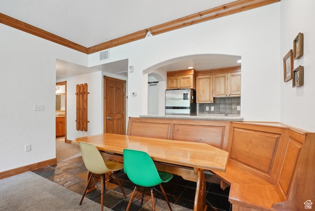 840 Bigler Ln Unit 2021, Midway, UT 84049 - dining room with arched walkways, baseboards, and stone tile flooring
