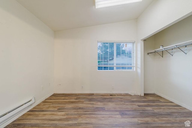 171 E 200 N, Orem, UT 84057 - unfurnished bedroom featuring a baseboard heating unit, wood finished floors, lofted ceiling, and baseboards