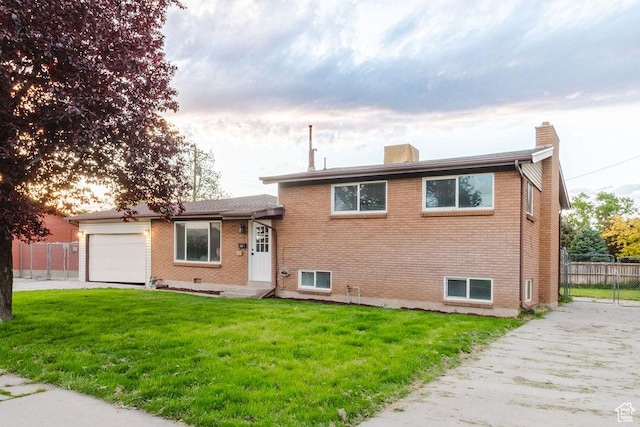 171 E 200 N, Orem, UT 84057 - tri-level home with a chimney, brick siding, a garage, and driveway