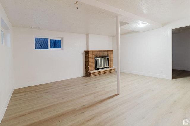 171 E 200 N, Orem, UT 84057 - finished below grade area with wood finished floors, a textured ceiling, a fireplace, and baseboards