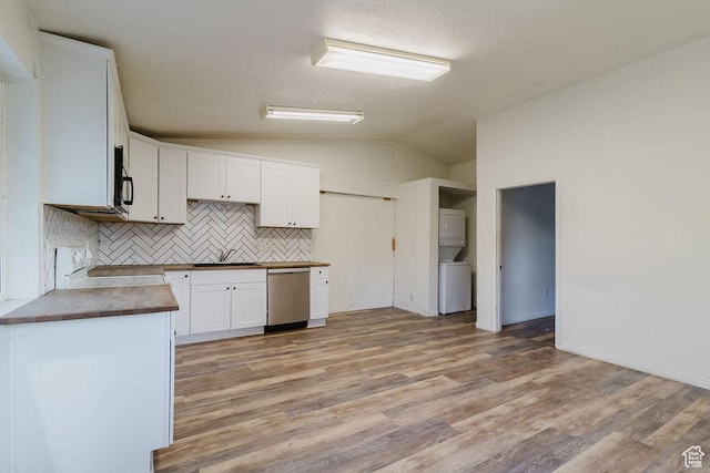 171 E 200 N, Orem, UT 84057 - kitchen with stacked washer / dryer, stainless steel dishwasher, vaulted ceiling, backsplash, and stove