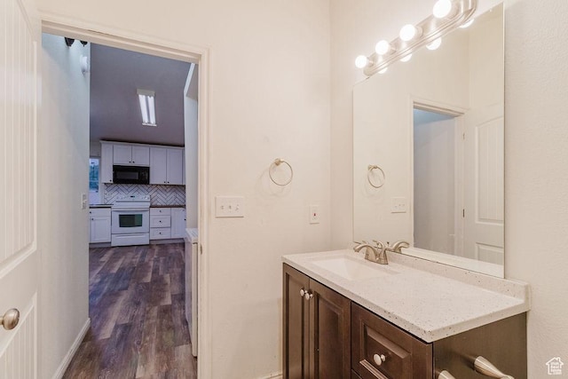 171 E 200 N, Orem, UT 84057 - bathroom with vanity, backsplash, and wood finished floors
