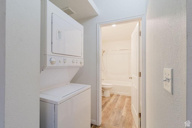171 E 200 N, Orem, UT 84057 - laundry room featuring estacked washer and dryer, light wood-style flooring, and a textured wall