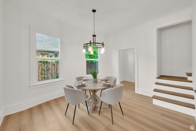 532 E 600 S, Salt Lake City, UT 84102 - dining space featuring light wood finished floors, a chandelier, baseboards, and stairway