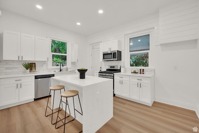 532 E 600 S, Salt Lake City, UT 84102 - kitchen featuring appliances with stainless steel finishes, decorative backsplash, light wood-style flooring, a kitchen island, and recessed lighting