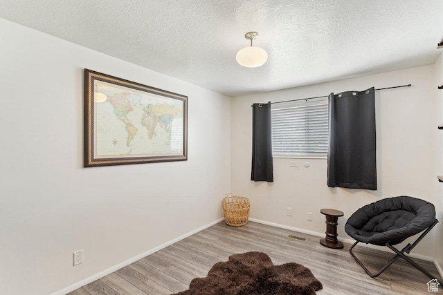 1162 S 885 E, Ogden, UT 84404 - sitting room with wood finished floors, baseboards, and a textured ceiling