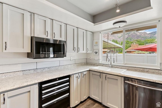 1162 S 885 E, Ogden, UT 84404 - kitchen featuring appliances with stainless steel finishes, a sink, beverage cooler, dark wood finished floors, and light stone countertops