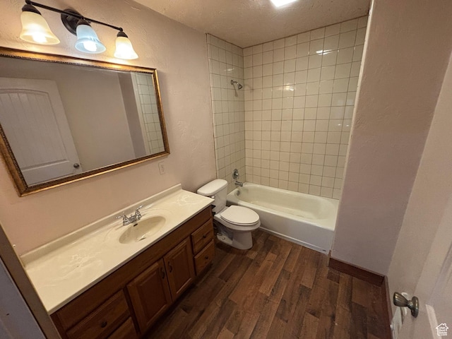 149 Thomas Fork Ln, Geneva, ID 83238 - bathroom featuring wood finished floors, vanity, toilet, a textured ceiling, and shower / washtub combination