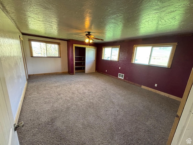 149 Thomas Fork Ln, Geneva, ID 83238 - spare room featuring a textured ceiling, a ceiling fan, carpet, and baseboards