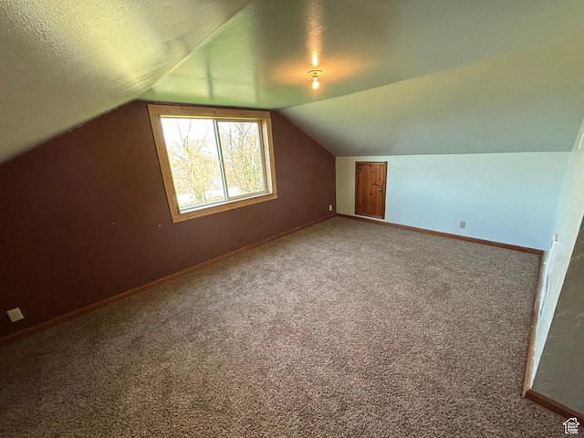 149 Thomas Fork Ln, Geneva, ID 83238 - additional living space with vaulted ceiling, baseboards, carpet flooring, and a textured ceiling