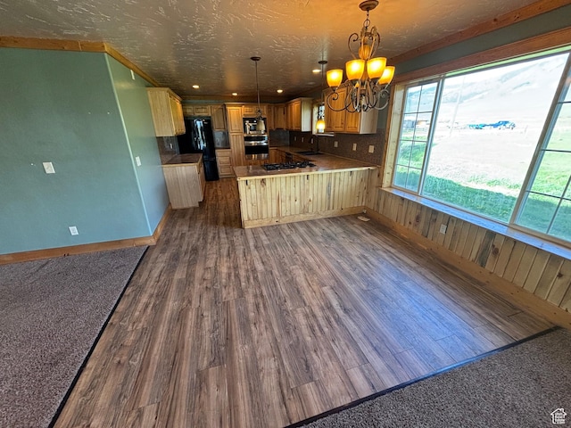 149 Thomas Fork Ln, Geneva, ID 83238 - kitchen with freestanding refrigerator, a chandelier, dark wood-style floors, a sink, and a peninsula