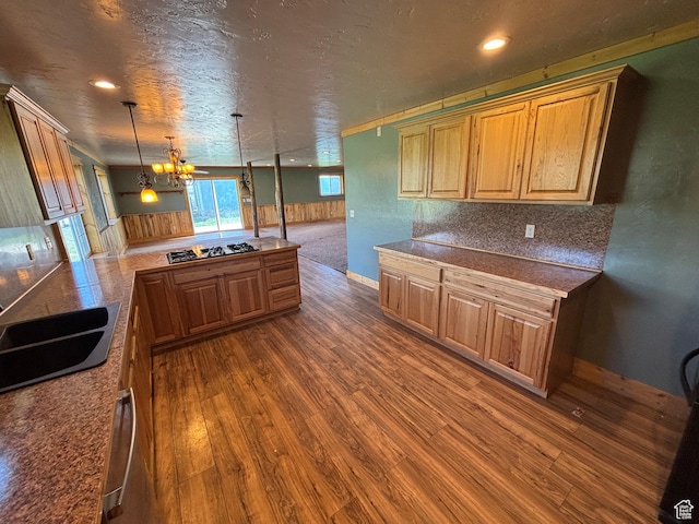 149 Thomas Fork Ln, Geneva, ID 83238 - kitchen featuring dark wood-style flooring, gas stovetop, a chandelier, a peninsula, and decorative light fixtures