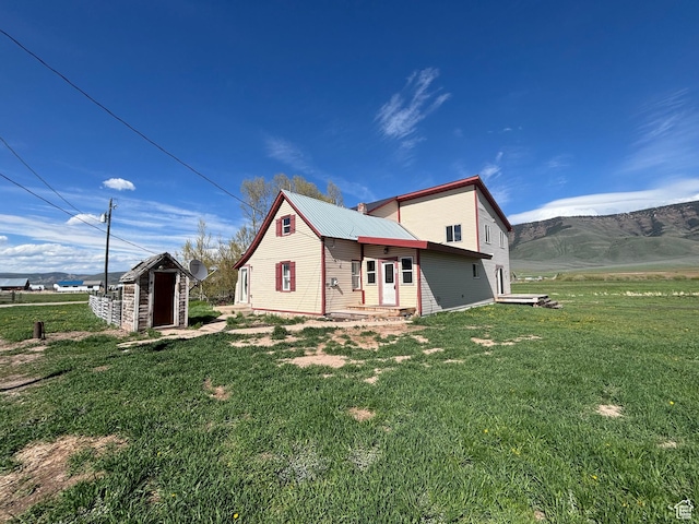 149 Thomas Fork Ln, Geneva, ID 83238 - view of side of home with a yard, metal roof, and entry steps