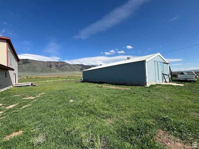 149 Thomas Fork Ln, Geneva, ID 83238 - view of green lawn with an outbuilding and a mountain view