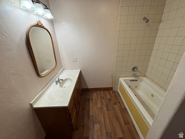 149 Thomas Fork Ln, Geneva, ID 83238 - bathroom with wood finished floors, vanity, a combined bath / shower with jetted tub, and baseboards