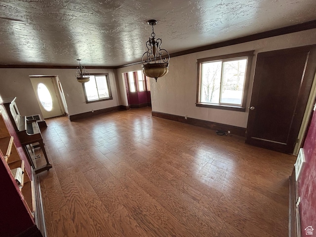 149 Thomas Fork Ln, Geneva, ID 83238 - unfurnished dining area featuring crown molding, wood finished floors, and baseboards