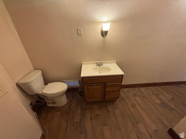 149 Thomas Fork Ln, Geneva, ID 83238 - bathroom featuring vanity, wood finished floors, toilet, and baseboards