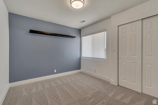 4917 W Stormy Meadow Dr, Riverton, UT 84096 - unfurnished bedroom featuring carpet flooring, a closet, and baseboards