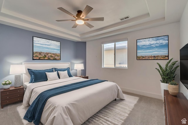 4917 W Stormy Meadow Dr, Riverton, UT 84096 - bedroom featuring a tray ceiling, light colored carpet, baseboards, and a ceiling fan