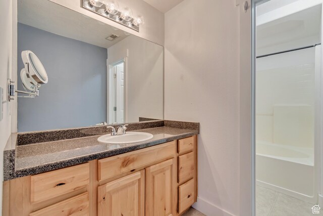 4917 W Stormy Meadow Dr, Riverton, UT 84096 - full bath with vanity, tile patterned floors, tub / shower combination, and baseboards