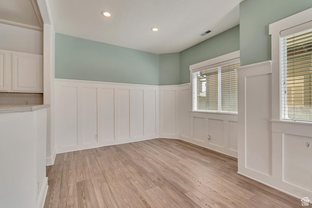 4917 W Stormy Meadow Dr, Riverton, UT 84096 - spare room with a decorative wall, a wainscoted wall, light wood-style floors, and recessed lighting