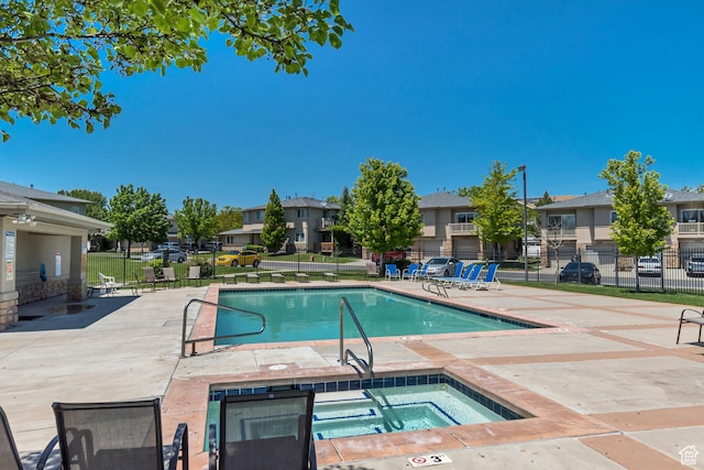 4917 W Stormy Meadow Dr, Riverton, UT 84096 - community pool with a residential view, a community hot tub, and a patio