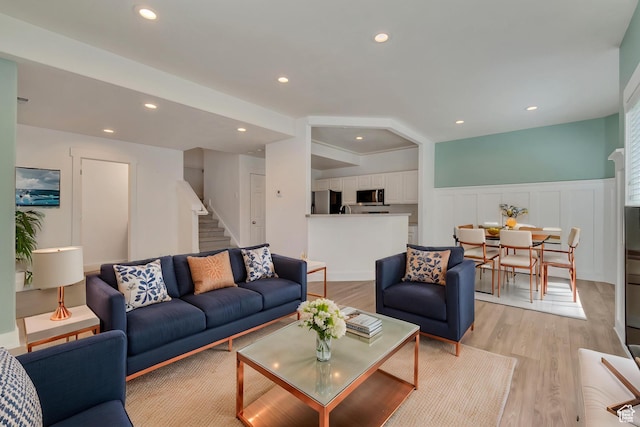 4917 W Stormy Meadow Dr, Riverton, UT 84096 - living area featuring stairs, a wainscoted wall, light wood-style flooring, recessed lighting, and a decorative wall
